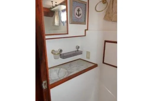 Slide: The Image of 1983 Chung Hwa Sedan Trawler bathroom with marble sink and nautical decor. - 20