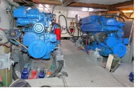Slide: The Image of Engine room of 1983 Chung Hwa Sedan Trawler with dual blue marine engines. - 21