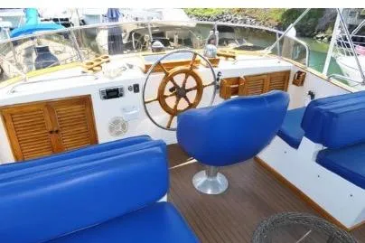 Slide: The Image of 1983 Chung Hwa Sedan Trawler cockpit with blue seating and wooden steering wheel. - 5