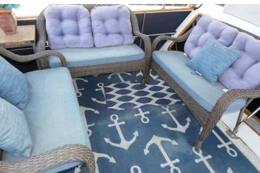 Slide: The Image of Cozy seating area on 1983 Chung Hwa Sedan Trawler with nautical-themed decor. - 6