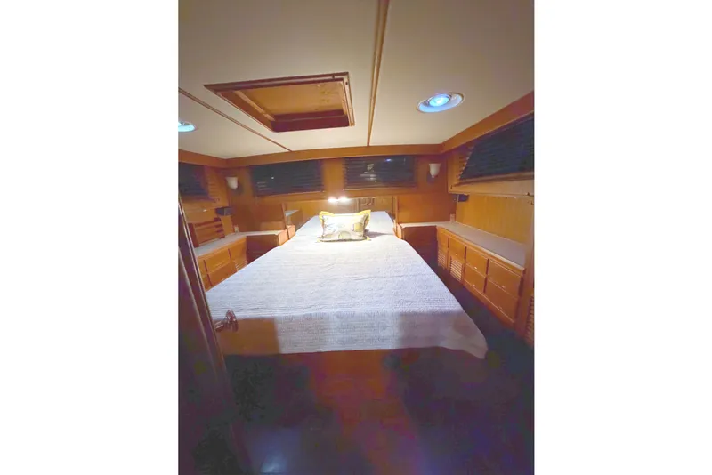 Slide: The Image of The image shows a cozy cabin with a double bed, wooden walls, and a skylight. - 18
