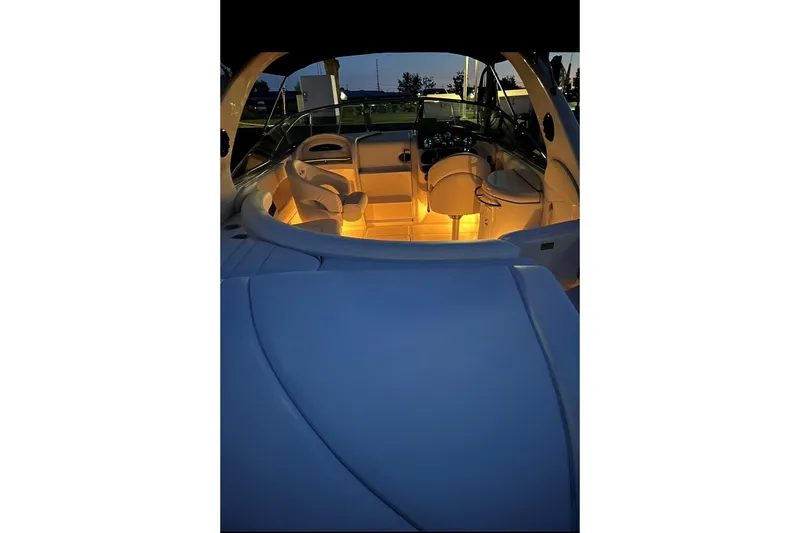Slide: The Image of Interior view of a 2001 Sea Ray 290 Sun Sport boat with ambient lighting. - 2