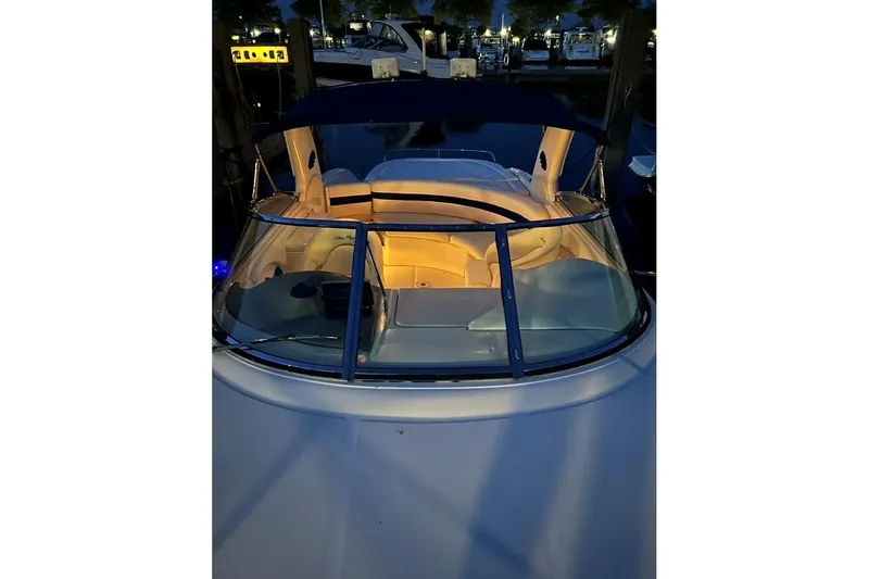 Slide: The Image of 2001 Sea Ray 290 Sun Sport boat with illuminated interior at night. - 3