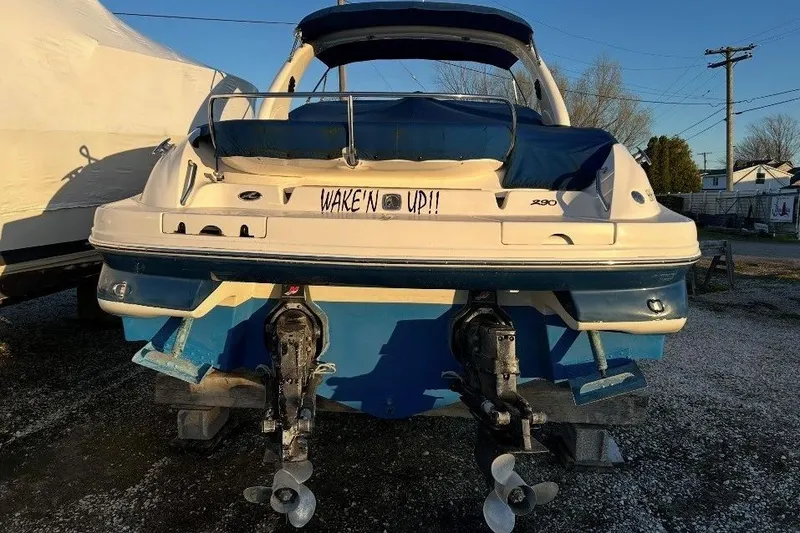 Slide: The Image of 2001 Sea Ray 290 Sun Sport boat with dual propellers, labeled "Wake'n Up!!". - 8