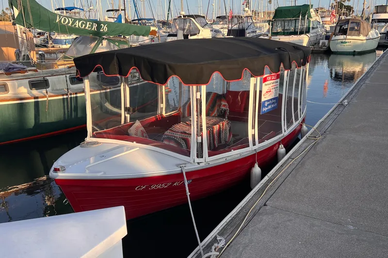 Slide: The Image of Red 2007 Duffy 16 electric boat docked, with black canopy and "For Sale" sign. - 3