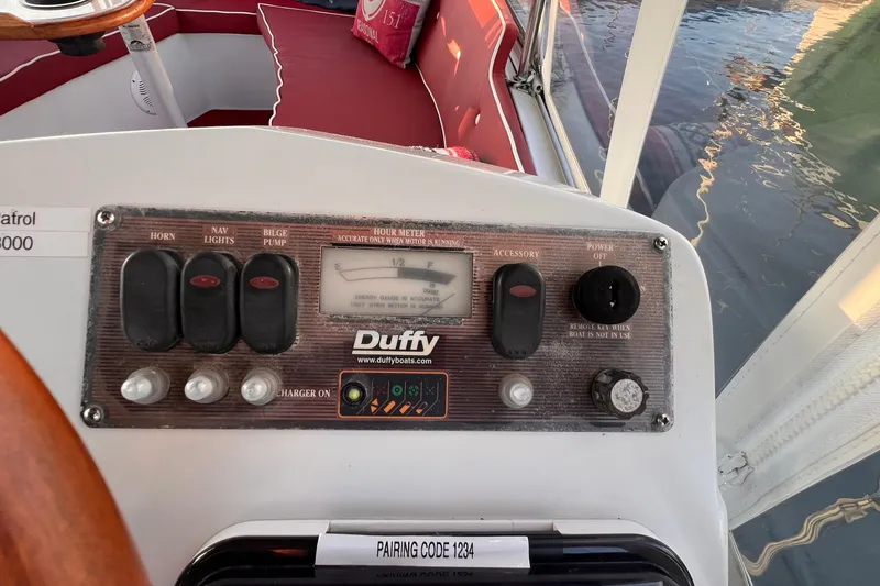 Slide: The Image of Control panel of a 2007 Duffy 16 boat with switches and gauges. - 5