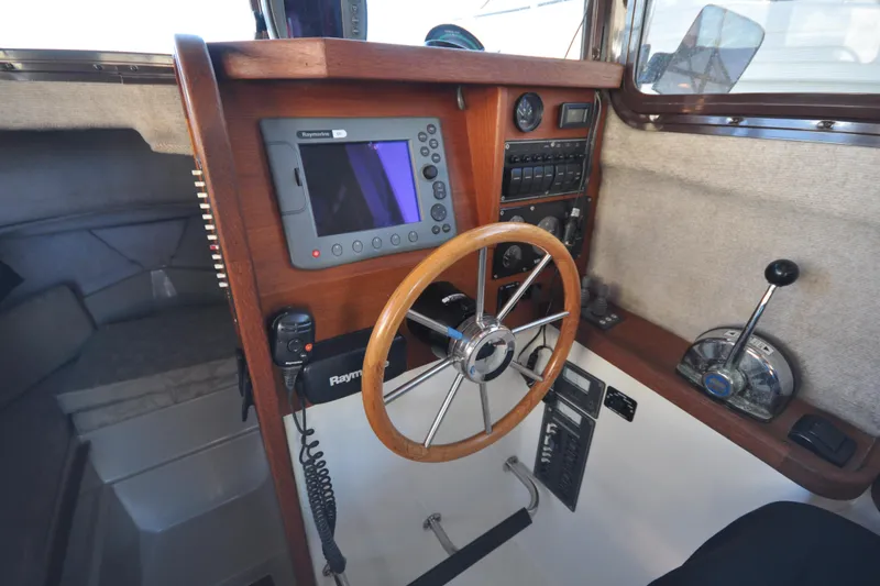 Slide: The Image of Interior helm of 2007 Ranger Tug R-25 with steering wheel and navigation equipment. - 10