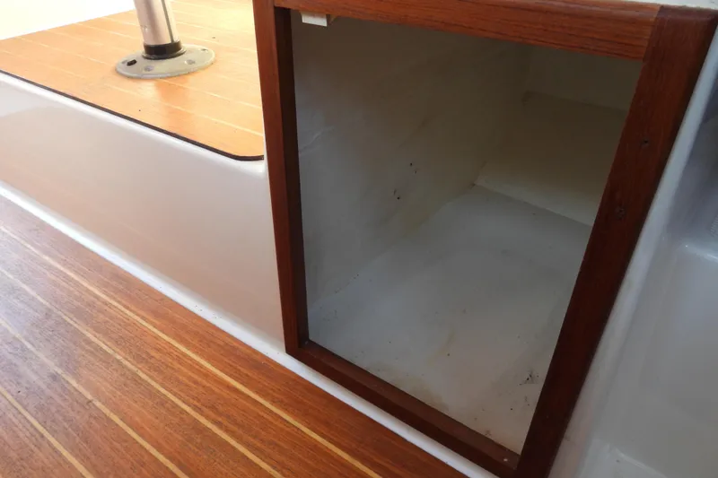 Slide: The Image of Storage compartment on 2007 Ranger Tug R-25 boat with wooden trim and flooring. - 16