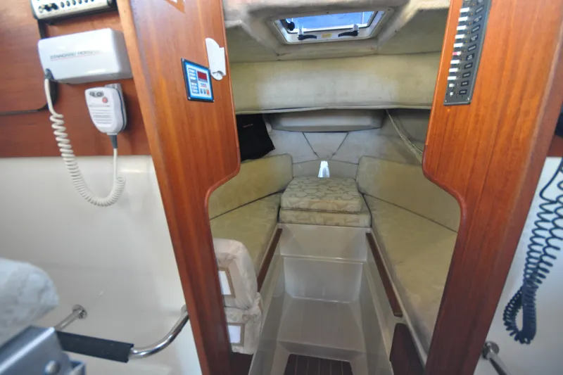 Slide: The Image of Interior cabin of 2007 Ranger Tug R-25 with cozy sleeping area and wooden accents. - 17