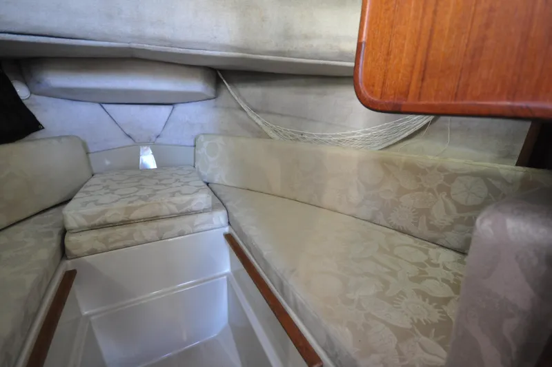 Slide: The Image of Interior cabin of 2007 Ranger Tug R-25 with cushioned seating and wooden accents. - 18