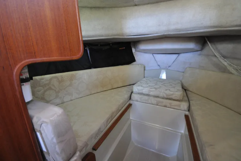 Slide: The Image of Interior cabin of 2007 Ranger Tug R-25 with cushioned seating and wooden accents. - 19