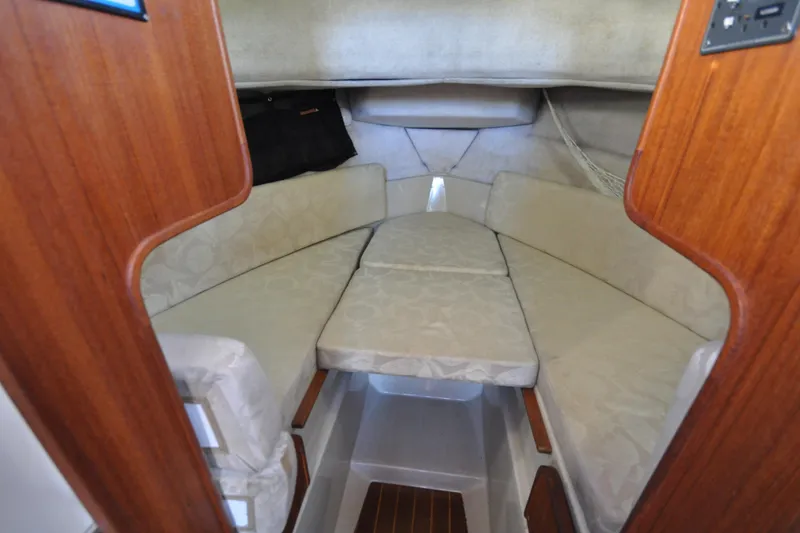 Slide: The Image of 2007 Ranger Tug R-25 cabin interior with cushioned seating and wooden accents. - 20