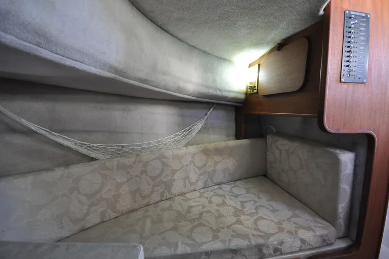 Slide: The Image of Cozy interior cabin of 2007 Ranger Tug R-25 with cushioned seating and net storage. - 22