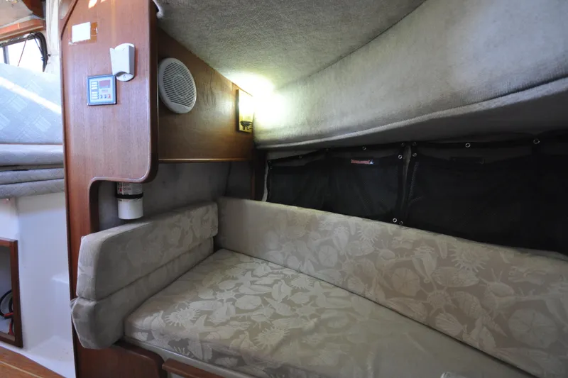 Slide: The Image of 2007 Ranger Tug R-25 interior cabin with cushioned seating and wooden paneling. - 23