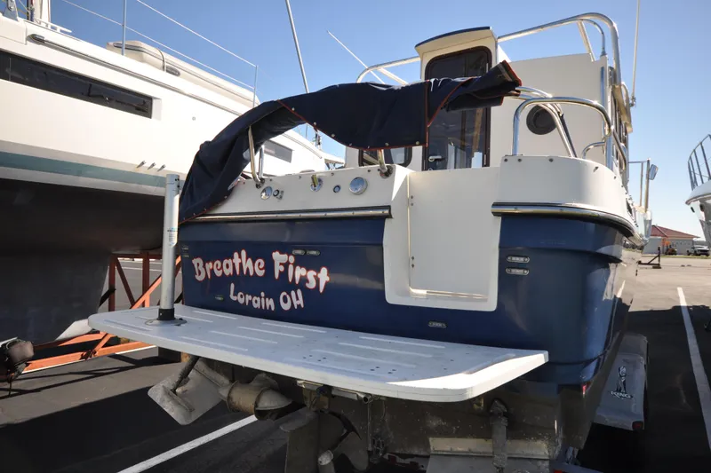 Slide: The Image of 2007 Ranger Tug R-25 boat named "Breathe First" in Lorain, Ohio, docked outdoors. - 6