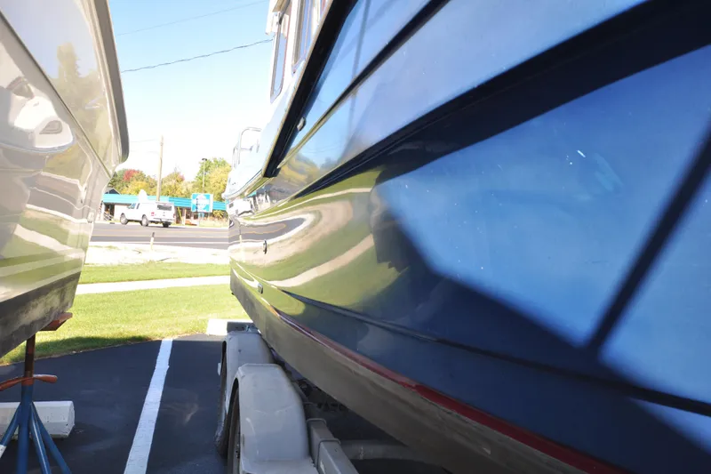 Slide: The Image of 2007 Ranger Tug R-25 boat on trailer, parked outdoors, side view. - 8