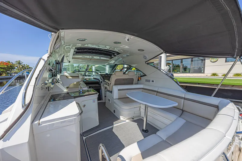 Slide: The Image of Luxurious 2014 Sea Ray 410 Sundancer yacht interior with seating and table. - 12