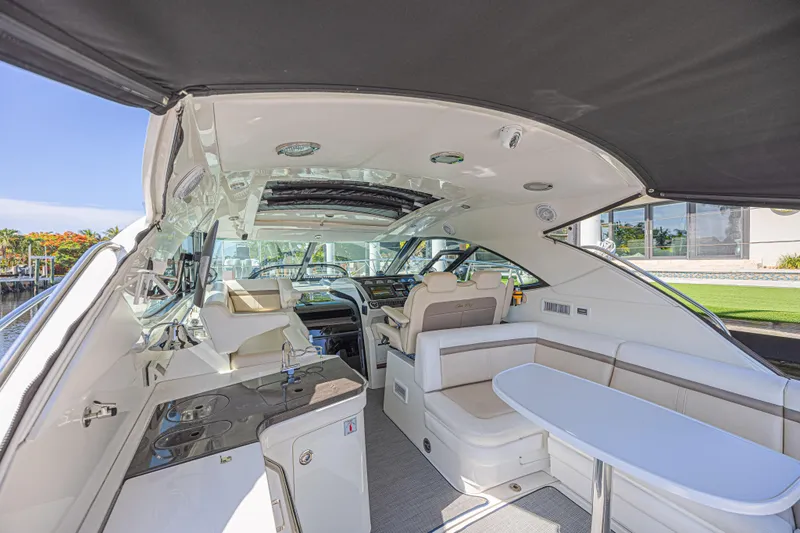 Slide: The Image of Luxurious interior of 2014 Sea Ray 410 Sundancer yacht with seating and helm. - 13