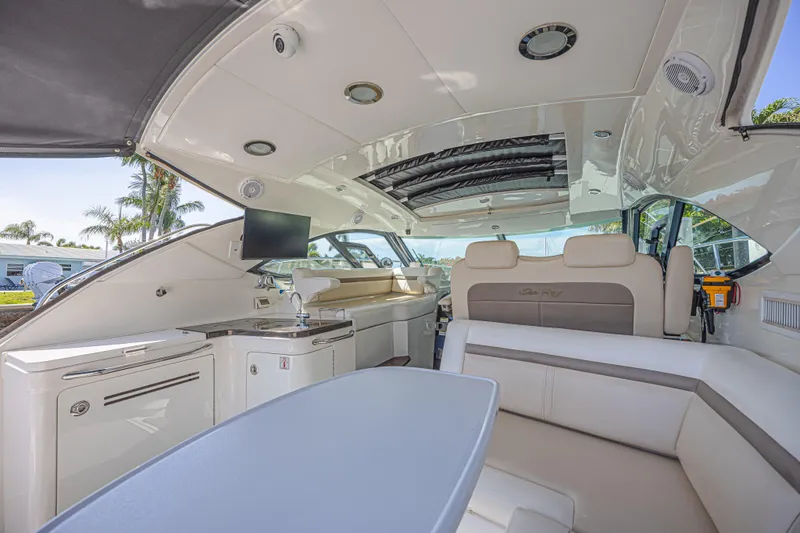 Slide: The Image of Luxurious interior of 2014 Sea Ray 410 Sundancer yacht with seating and entertainment area. - 14
