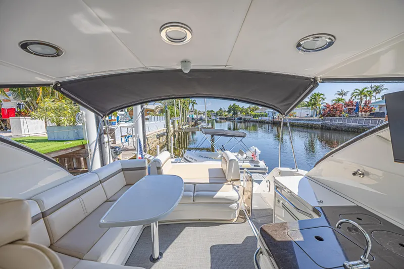 Slide: The Image of Luxurious 2014 Sea Ray 410 Sundancer yacht interior with seating and waterfront view. - 17