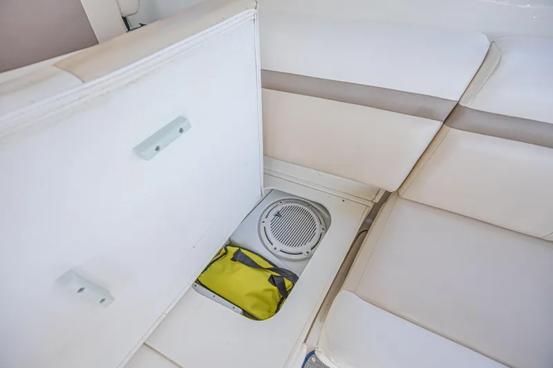 Slide: The Image of Storage compartment on 2014 Sea Ray 410 Sundancer boat with speaker and yellow bag. - 22