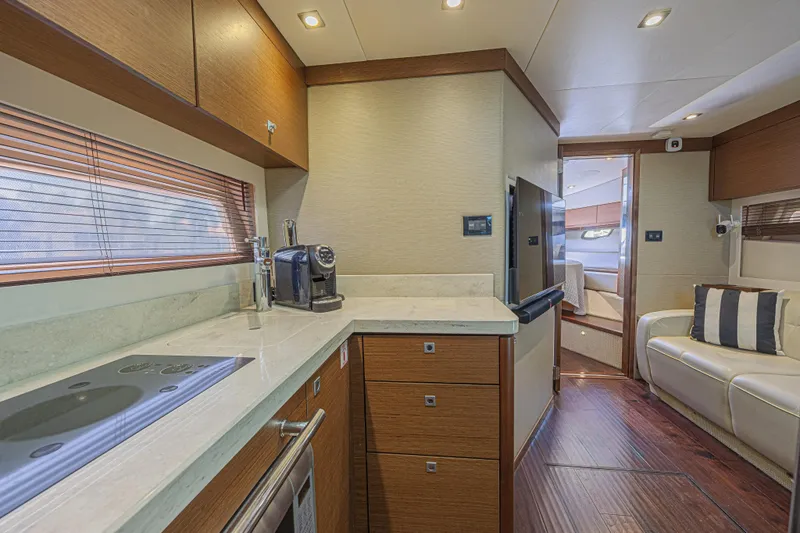 Slide: The Image of Luxurious interior of 2014 Sea Ray 410 Sundancer yacht with modern kitchen and cozy seating. - 24