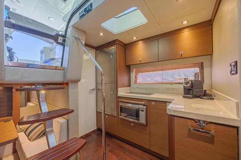 Slide: The Image of Luxurious interior of 2014 Sea Ray 410 Sundancer yacht with modern kitchen amenities. - 25
