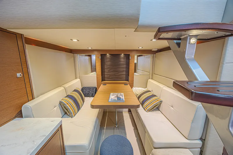 Slide: The Image of Luxurious interior of 2014 Sea Ray 410 Sundancer yacht with elegant seating and table. - 29