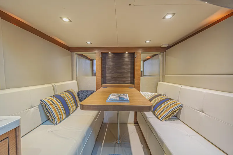 Slide: The Image of Luxurious interior of 2014 Sea Ray 410 Sundancer yacht with elegant seating and table. - 30