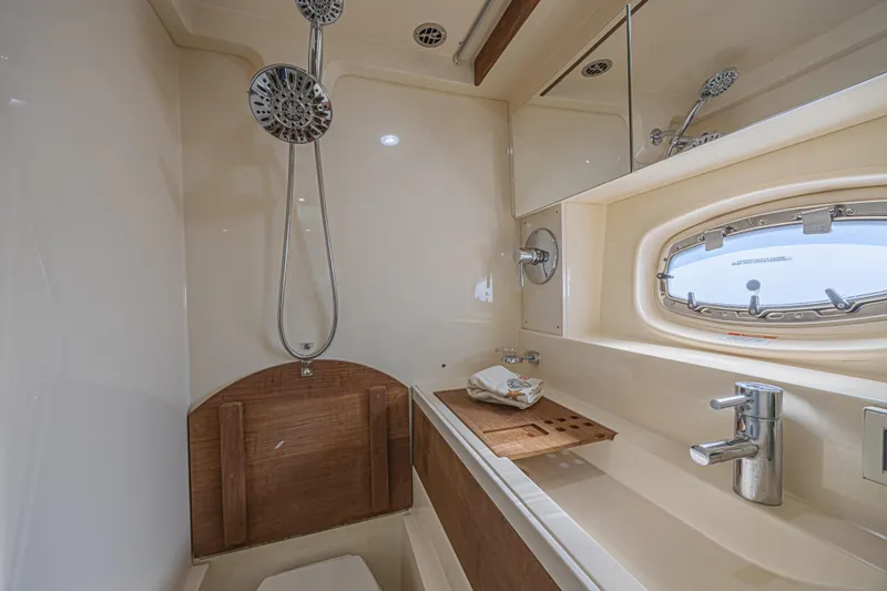 Slide: The Image of Luxurious bathroom in 2014 Sea Ray 410 Sundancer yacht with shower and porthole window. - 33