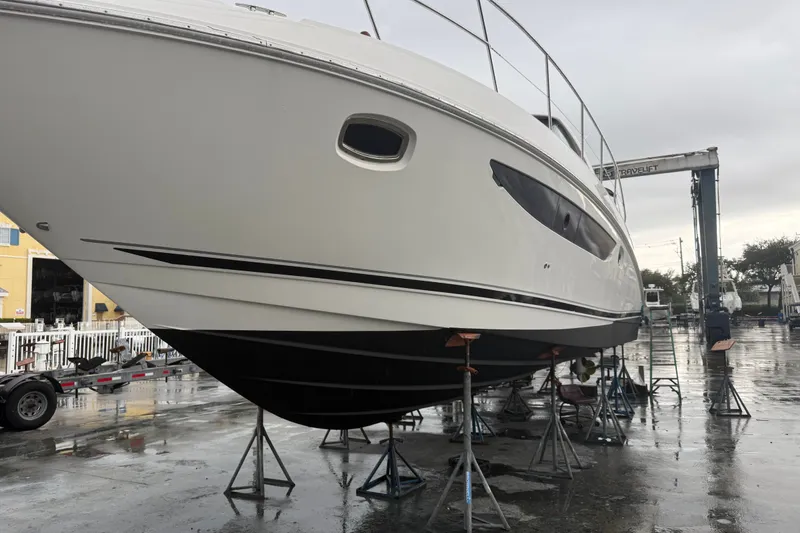 Slide: The Image of 2014 Sea Ray 410 Sundancer yacht on stands in a marina setting. - 39