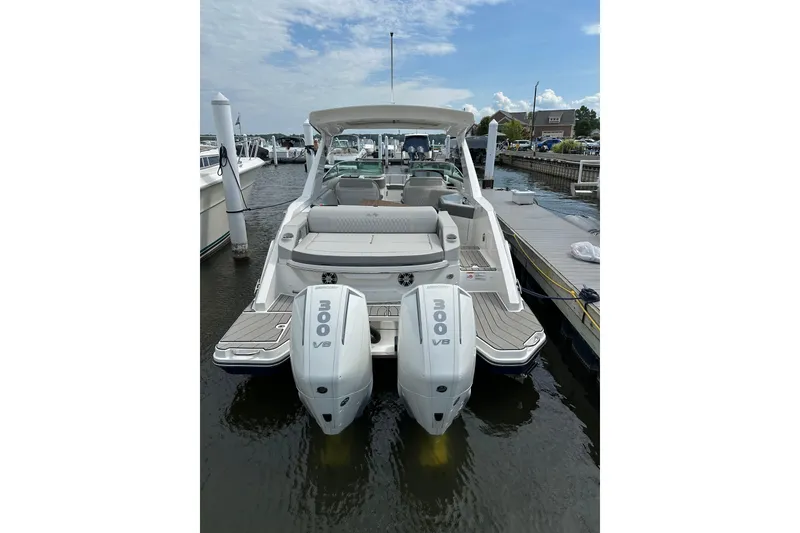 The Image of 2025 Sea Ray SLX 310 Outboard boat docked with twin 300 V8 engines. - 0