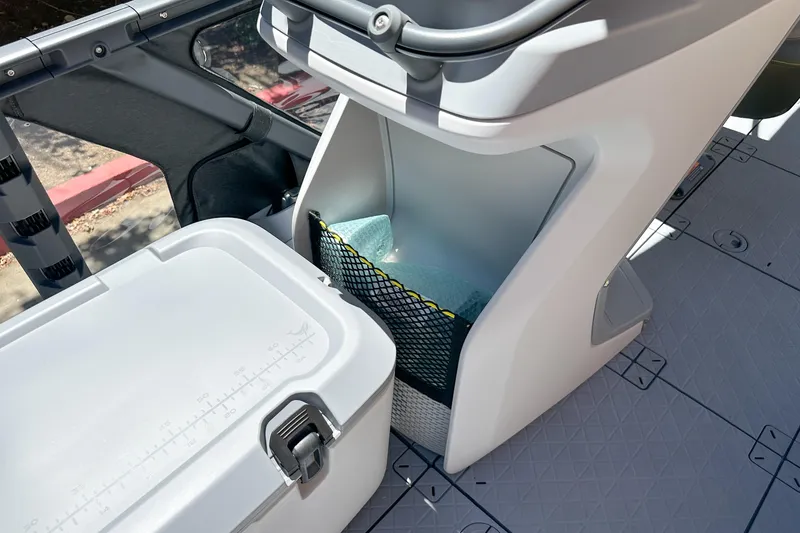 Slide: The Image of 2026 Sea-Doo Switch Fish 21 boat interior with storage compartment and cooler. - 15
