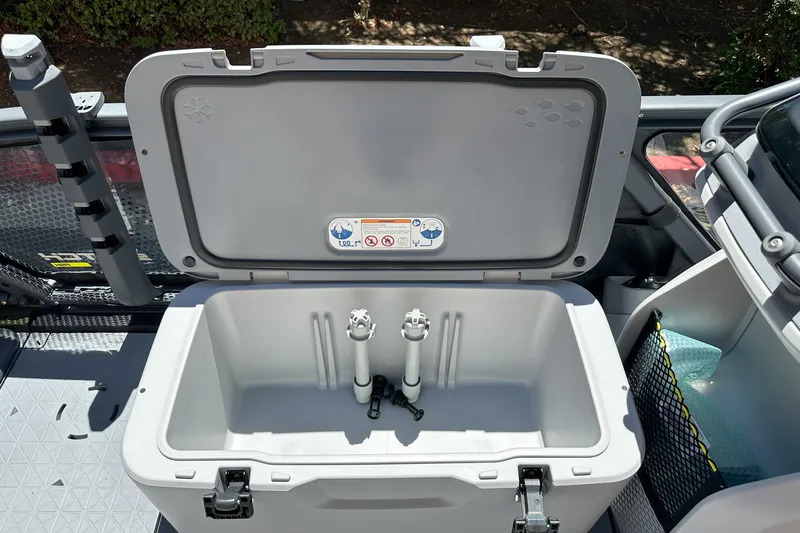 Slide: The Image of Open storage compartment on 2026 Sea-Doo Switch Fish 21 boat, featuring organized interior space. - 16