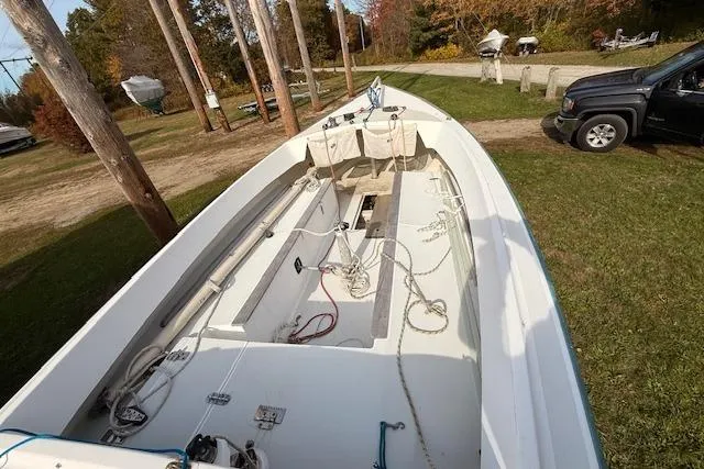 Slide: The Image of 1998 Alerion Express 20 sailboat on grassy area, showcasing deck and rigging details. - 10