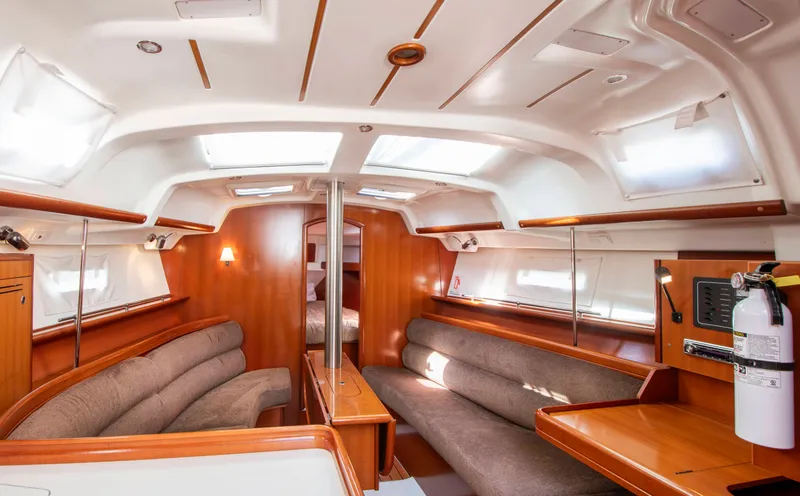 Slide: The Image of Interior of a Beneteau 343 yacht with wooden furnishings and seating areas. - 10