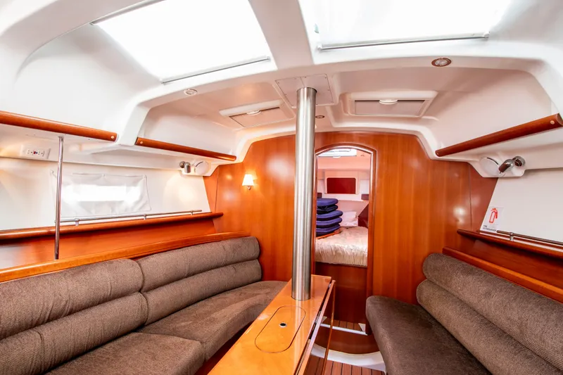 Slide: The Image of Interior of a Beneteau 343 yacht with wood paneling and seating. - 13