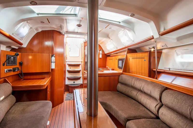 Slide: The Image of Interior of a Beneteau 343 yacht with wooden furnishings and seating. - 15