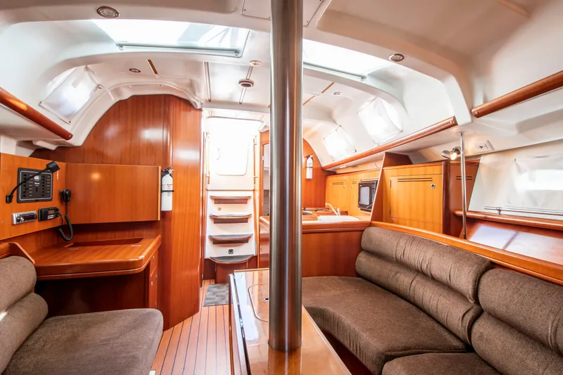 Slide: The Image of Interior of a Beneteau 343 yacht with wood paneling and seating area. - 16