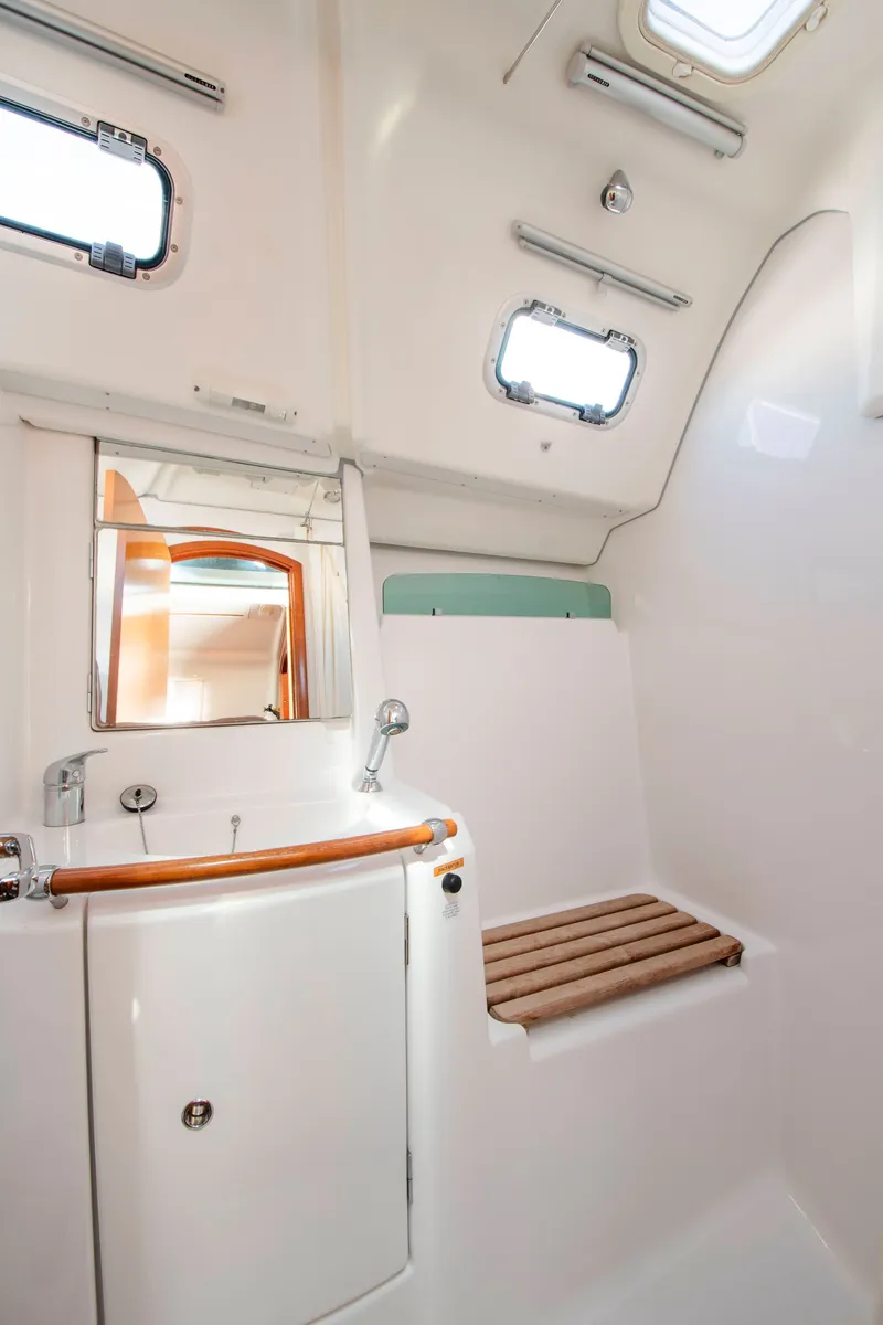 Slide: The Image of Interior of a Beneteau 343 yacht with a sink and wooden accents. - 22