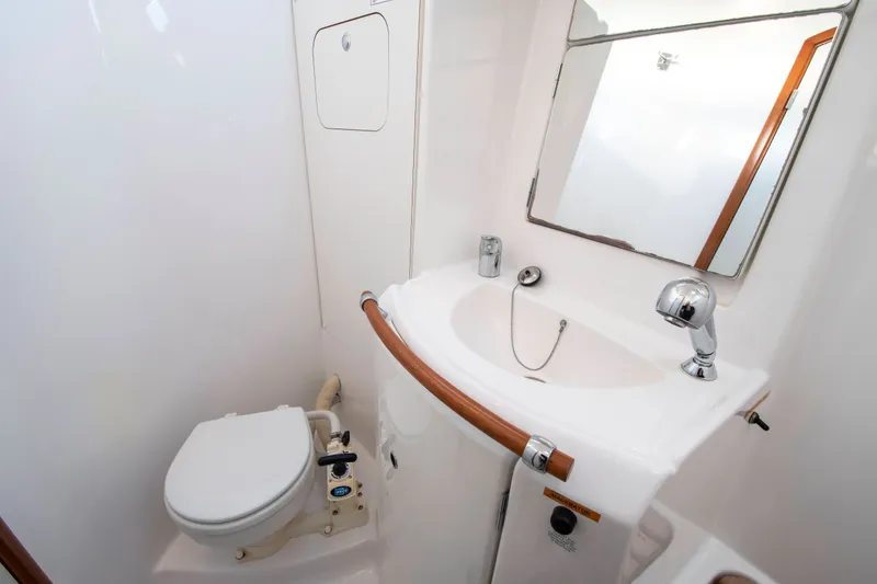 Slide: The Image of Interior of a boat cabin with a sink and toilet. - 23