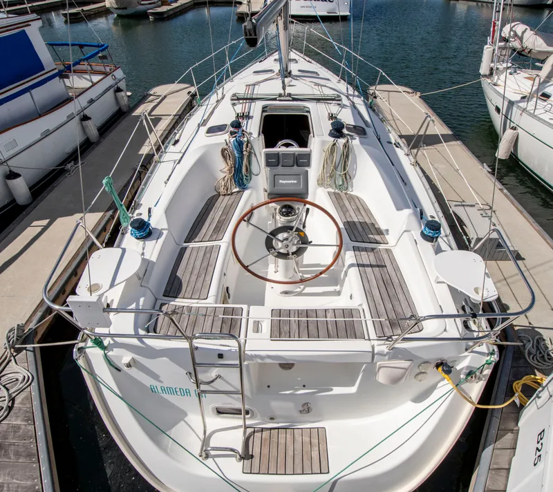 Slide: The Image of A Beneteau 343 sailboat docked in a marina, surrounded by other boats. - 3