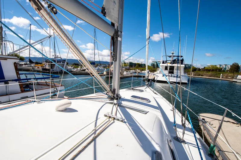 Slide: The Image of Sailboat in a marina with blue sky and other boats in the background. - 7