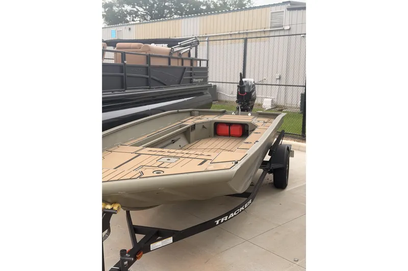The Image of 2026 Tracker Grizzly 1756 MARSH boat on trailer, parked outdoors. - 1