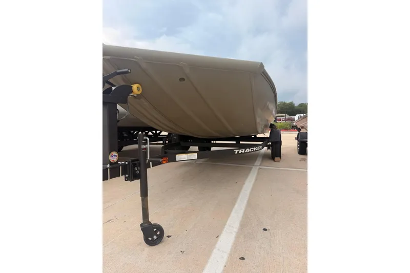 Slide: The Image of 2026 Tracker Grizzly 1756 MARSH boat on trailer, parked outdoors. - 11