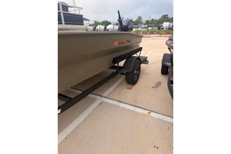 Slide: The Image of 2026 Tracker Grizzly 1756 MARSH boat on trailer in parking lot. - 12