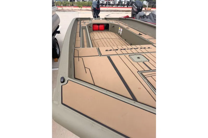 Slide: The Image of 2026 Tracker Grizzly 1756 MARSH boat with tan deck and storage compartments. - 4