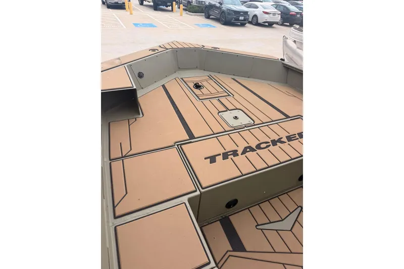 Slide: The Image of 2026 Tracker Grizzly 1756 MARSH boat interior with tan deck in parking lot. - 7