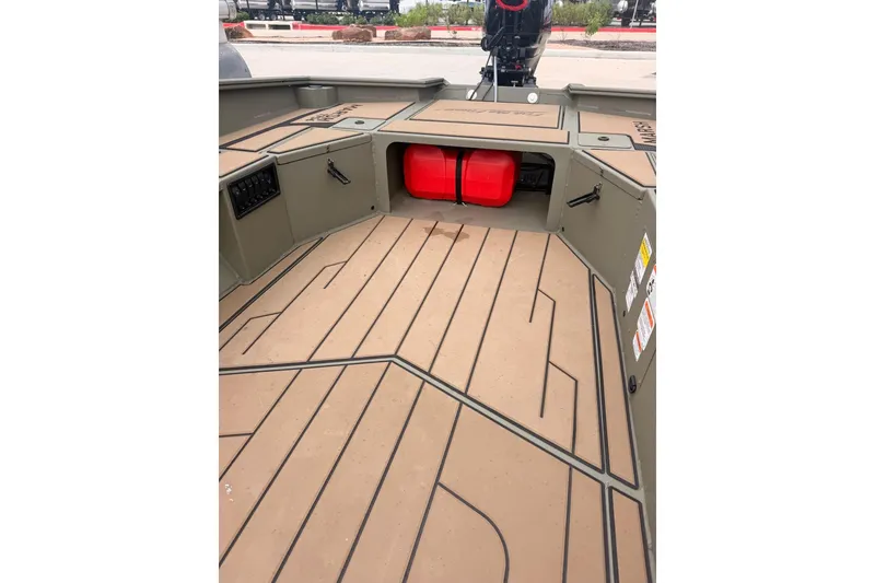 Slide: The Image of 2026 Tracker Grizzly 1756 MARSH boat interior with storage compartments and red fuel tank. - 8