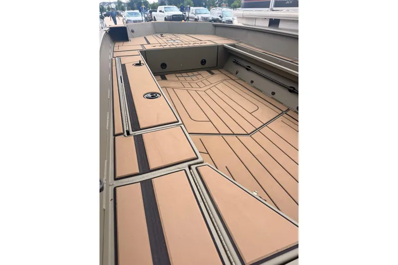 Slide: The Image of 2026 Tracker Grizzly 1756 MARSH boat interior with tan deck and storage compartments. - 9